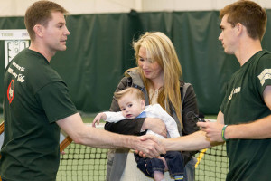 Alex Fish '06 receives a token of support from the men's tennis program Sunday. COURTESY PHOTO / TRIBE ATHLETICS