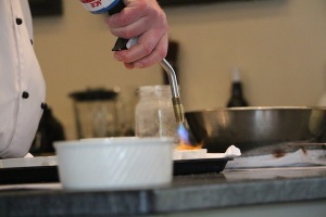 A chef putting the finishing touches on chocolate crème brûlée. TUCKER HIGGINS / THE FLAT HAT.