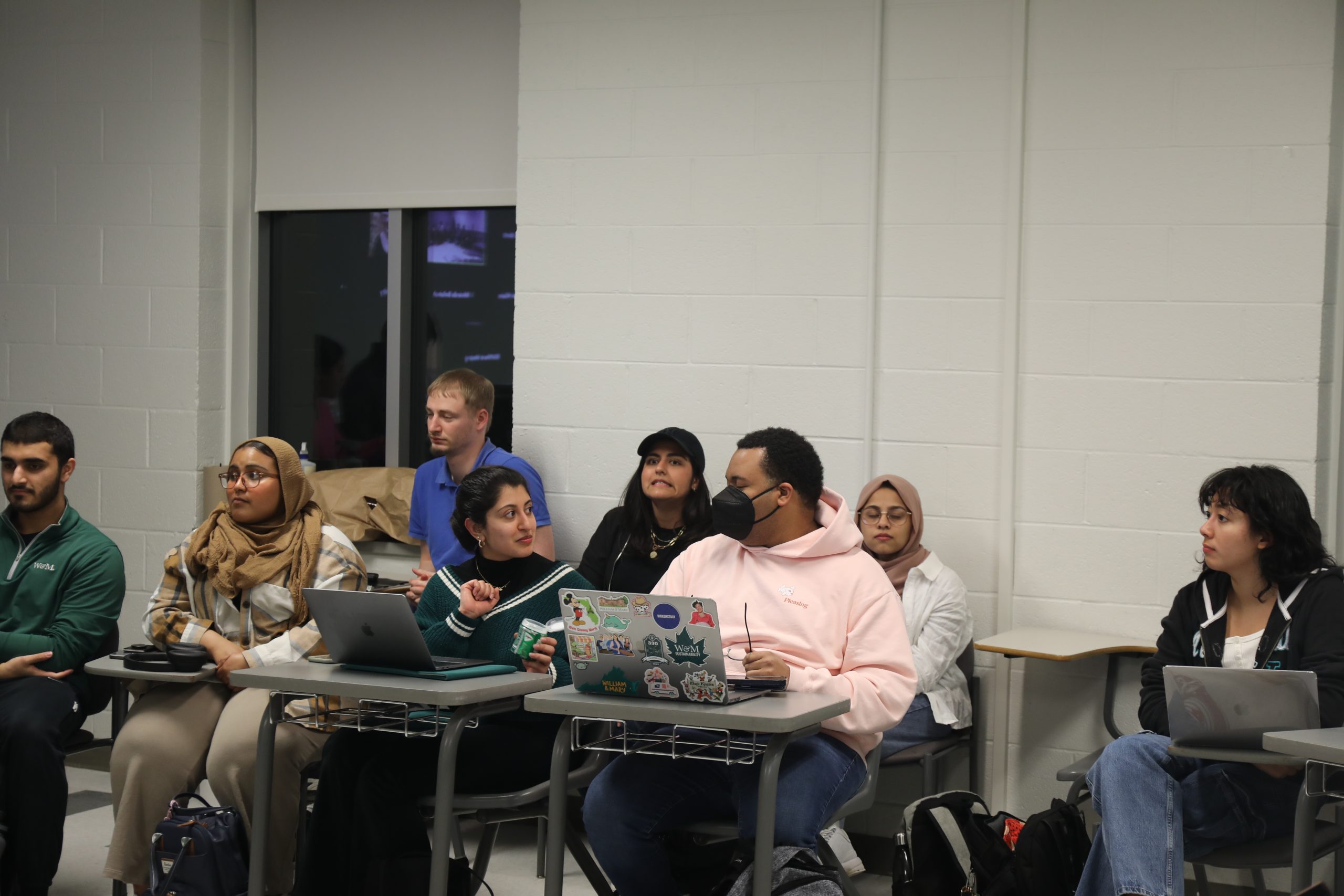 GSA of the Arts and Sciences President Justin Cammarota sitting next to MSA President Zyannah Mallick ’23 (back row). Class President Maheen Saeed '23 talking to Sen. Justin Bailey '24, while Class President Yannie Chang '25 observes the meeting.  PEERAWUT RUANGSAWASDI // THE FLAT HAT